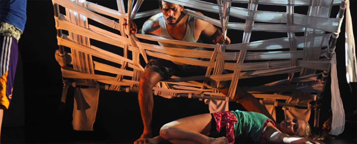 a man pokes himself through a woven bed